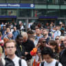 Passengers gather outside Manchester Piccadilly train station after a major disruption to rail service in the Midlands and northwest England on August 06, 2026 in Manchester, England.