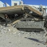 Palestinians walk past a destroyed Israeli armored vehicle left behind by the Israeli army during the recent war, in the Tel al-Hawa neighborhood of Gaza City, September 7, 2026.