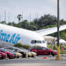 Tesla cars are parked in a lot next to where a crashed Amazon Prime Air cargo plane came to rest, where airport officials said it overran a runway at Miami International Airport, in Miami, Florida, US, September 7, 2026. 