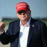 US President Donald Trump holds his fist up after disembarking from Air Force One upon arrival at Joint Base Andrews, Maryland on September 7, 2026.