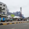 Smoke rises during Houthi missile and drone strikes on the Red Sea port city of Mocha, Yemen, August 9, 2026. Picture taken with a mobile phone. 