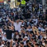 Jewish men in the street during Tikkun HaKlali near the tomb of Rabbi Nachman of Breslov in Uman, on eve of the Jewish holiday of Rosh Hashanah, September 22, 2025.