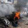Residents attempt to extinguish a fire following an Israeli airstrike that hit a vehicle in Gaza City, August 31, 2026.