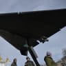 People look at an Iranian-designed HESA Shahed 136 (Geran-2) drone at an open-air exhibition of destroyed Russian military equipment on Mykhailivska Square in front of Saint Michael's Golden-Domed Cathedral, in Kyiv, on April 7, 2026.