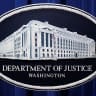 A U.S. Justice Department logo or seal showing Justice Department headquarters, known as "Main Justice," is seen behind the podium in the Department's headquarters briefing room before a news conference with the Attorney General in Washington, January 24, 2023. 