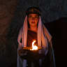 A Yazidi woman holds a candle during a ceremony marking Charshama Sor, or Red Wednesday, the Yazidi New Year, at Lalish temple in Shaikhan near Dohuk in northern Iraq on April 14, 2026. Northern Iraq's Kurdistan Region is home to the Yazidi religious minority.