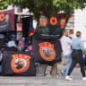 People pass near a banner depicting former Kosovo's President Hashim Thaci and former parliament speaker Kadri Veseli, in Skenderaj, Kosovo September 15, 2026.