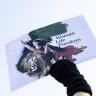 A woman hand holds a sign with drawings of a lion and an Iranian woman and the slogan Woman Life Freedom in Paris in France on January 18, 2026. Demonstration in support of the Iranian uprising against the Islamic and in favor of the return of Reza Pahlavi.