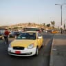 A man drives a Careem taxi car in Mosul, Iraq.