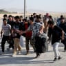 Afghan nationals carrying their belongings walk after crossing the border from Iran at the Islam Qala border crossing in Herat province, Afghanistan, September 3, 2026. 