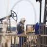 A WORKER rests next to an oil pump in Baku, Azerbaijan. 