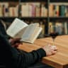 Reading with wine in a quiet library.