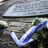 This photo taken on July 25, 2018 shows flowers from the Croatian and Israeli presidents on the plaque at the memorial in the shape of a flower in Jasenovac where the two presidents payed a tribute for the victims killed at the Jasenovac concentration camp which was dismantled 73 years ago.