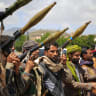 Supporters of the Iran-backed Houthi movement, brandish their weapons as they rally in solidarity with Iran and Lebanon, in Sanaa on April 8, 2026, following the announcement of a ceasefire in the Middle East war.