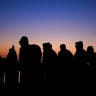 People wait for relocation at Benitez beach settlement following the mass crossing of migrants from Morocco, in Ceuta, Spain, September 16, 2026.