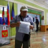 A voter reads his ballot at a polling station during Russia's parliamentary election, in the course of Russia-Ukraine conflict, in Donetsk, Russian-controlled Ukraine, September 18, 2026.