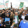 Supporters of the Houthis brandish their weapons during a protest against the Saudi intervention in Yemen and against Saudi Arabia after the Houthis fired at the holy city of Mecca, in Sanaa on September 18, 2026. 