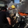 Palestinians attempt to extinguish a fire following an Israeli air strike that hit a vehicle in Gaza City, September 19, 2026.