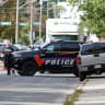 Police officers talk near the scene of a shooting where a police officer was shot outside a Yom Kippur gathering at Sons of Jacob Synagogue in Belleville, Ontario, Canada, September 21, 2026.