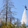 A firefighting helicopter makes a water drop in the path of the Lucas Fire burning near Upper Lake, a community in Lake County, California, US, September 12, 2026.
