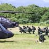 Taiwanese soldiers carry fuel supplies towards AH-64E Apache Guardian and UH-60M Black Hawk helicopters during a refueling drill as part of the annual Han Kuang military exercise in Taoyuan on August 11, 2026