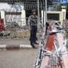 A police official stands guard in front of Insein Prison during an annual amnesty to mark Myanmar's independence day in Yangon on January 4, 2026. 