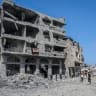 Residents stand near a heavily damaged residential building surrounded by rubble in the Al-Tuffah neighborhood of Gaza City, Gaza Strip on September 22, 2026. 