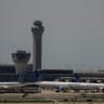 The control tower is pictured as planes are seen on the tarmac after an air traffic control outage, bringing flights to a standstill at Newark International Airport in Newark, New Jersey, US, May 11, 2025.