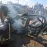 Palestinians inspect a vehicle hit by an Israeli airstrike in Khan Younis in the southern Gaza Strip, September 23, 2026.