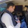 A journalist prepares equipment inside a vehicle in northern Gaza.
