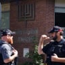 Police officers talk near the scene of a shooting where a police officer was shot outside a Yom Kippur gathering at Sons of Jacob Synagogue in Belleville, Ontario, Canada, September 21, 2026.