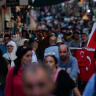 Illustrative: Customers walk past a flag vendor as they shop at a bazaar in Istanbul on September 6, 2022. 