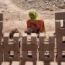 Pakistani girl helps make bricks at a kiln during World Day Against Child Labour on the outskirts of Islamabad on June 12, 2014. 