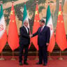 Iranian President Masoud Pezeshkian and Chinese President Xi Jinping shake hands as they meet in Beijing, China, September 2, 2025.