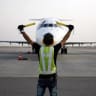 A ground controller directs an airliner on the apron on August 29, 2015 at the international airport of the city of Najaf as Iraqis are heading to Saudi Arabia to perform the annual Muslim Hajj pilgrimage in the holy city of Mecca. 