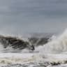 A surfer catches a wave as a nor'easter batters the US northeast coast, in Rockaway, New Jersey, US, September 26, 2026.