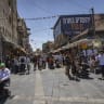 People shop at the Mahane Yehuda market on the first day of the Jewish holiday of Sukkot, in Jerusalem, September 27, 2026