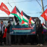 Protesters hold Palestinian flags, flags with the logo of Germany's Die Linke (The Left) party, and a banner during a pro-Palestinian demonstration, in Leipzig, Germany January 17, 2026. The banner reads: 'Stop the occupation and genocide! For freedom and equality between the Jordan and the Mediterr