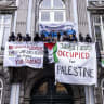 Students display banners as they occupy the socio-cultural sciences faculty building of Maastricht University (UM) in support of Palestinian people, in Maastricht on May 22, 2024.