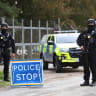 Armed police officers stand guard on a road outside the perimeter of the RAF Fairford airbase, after police declared a major incident at the base after several men were arrested on suspicion of offences under the Explosives Act, in Fairford, Gloucestershire, Britain, September 28, 2026. 