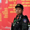 A police officer stands in front of posters for the 14th Congress of the Communist Party of Vietnam outside the National Convention Center in Hanoi on January 19, 2026. 