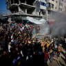 Palestinians attempt to extinguish a fire following an Israeli airstrike that hit a vehicle in Gaza City, September 19, 2026