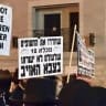 Ultra-Orthodox (haredi) protesters hold signs at a massive anti-draft march in Jerusalem, September 29, 2026.