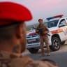 Military personnel stand guard near the site of explosions at an army weapons depot in the Al-Hadaba area near Aleppo, Syria, on September 21, 2026.