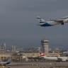 An ElAl plane takes off as a flydubai aircraft carrying passengers from flight FZ1073 arrives at Ben Gurion International Airport near Tel Aviv, after a suspected terror attack aboard their original flight from Dubai to Israel forced an emergency landing in Saudi Arabia, September 30, 2026.