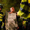 A protester is detained by Police outside the conference venue during the Mass Action Protest in support of the proscribed group Palestine Action on the first day of the Labour Party Conference at Liverpool Experience Campus.