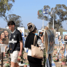 Visitors to the site of the Nova music festival.
