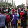 Burundian nationals stand outside their country's embassy as they seek travel documents to return to Burundi despite Kenya's government offering a temporary amnesty to undocumented East African nationals fearing a crackdown on small-scale traders from abroad, in Nairobi, Kenya, September 8, 2026.