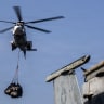 A Eurocopter AS-332 Super Puma helicopter delivers supplies on the flight deck of Nimitz-class aircraft carrier USS Abraham Lincoln, which is supporting US military operations in the war with Iran, during a replenishment-at-sea with fleet replenishment oiler USNS Henry J. Kaiser August 16, 2026. 