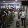 Passengers from Flydubai flight FZ1073 walk with their family members through the arrivals hall at Ben Gurion International Airport near Tel Aviv, after their original flight from Dubai to Israel was diverted to Saudi Arabia following a suspected terror attack, September 30, 2026.
